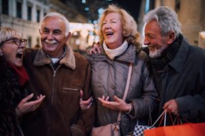 Two couples at nightlife laughing together.