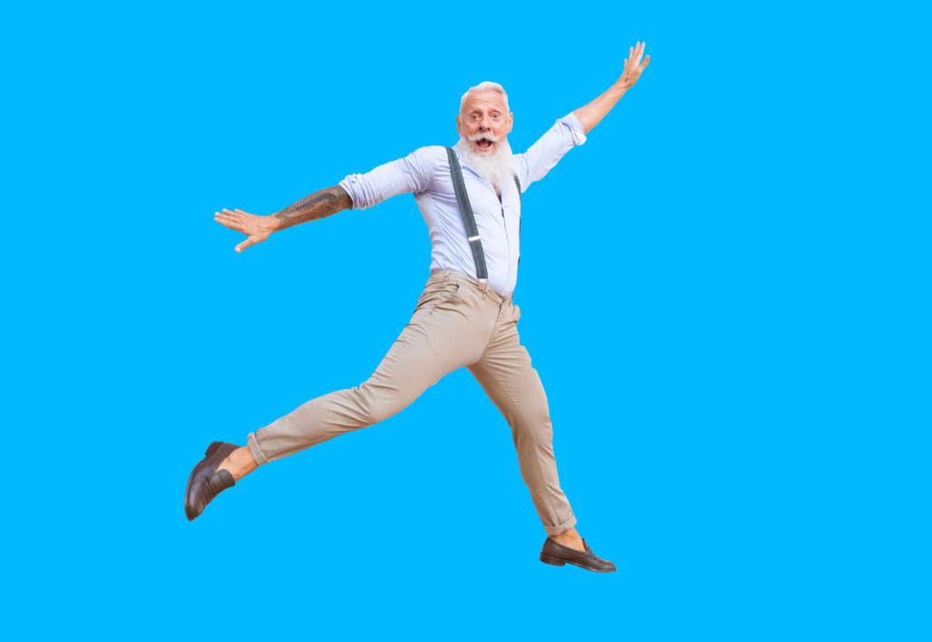 Older man in office clothing jumping